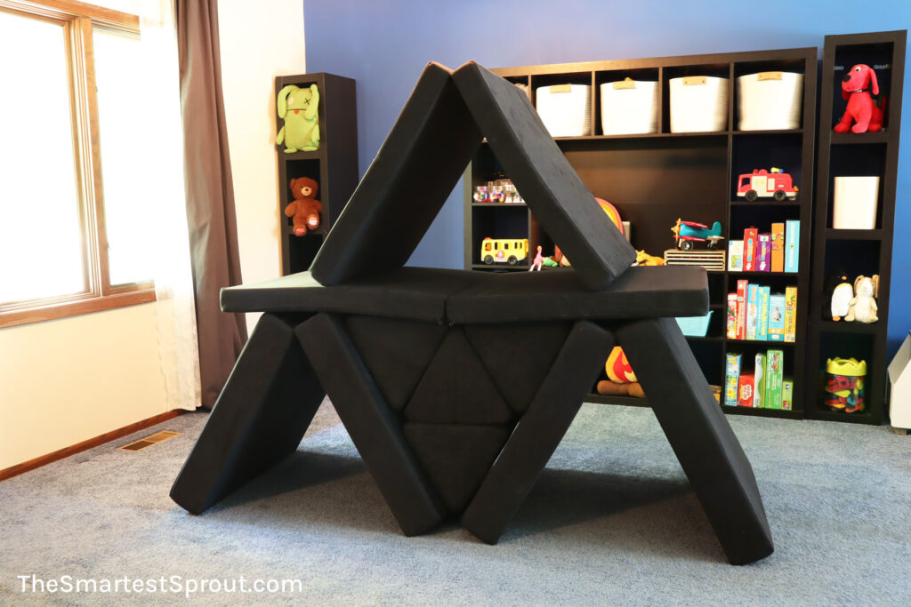 Triplet tower nugget fort built with two Nugget play couches featuring three hideaway spaces for kids indoor play