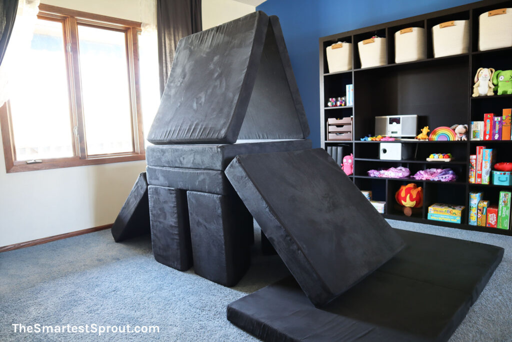 Tree Fort nugget build made with two Nugget play couches featuring a climb-up fort and slide for indoor play