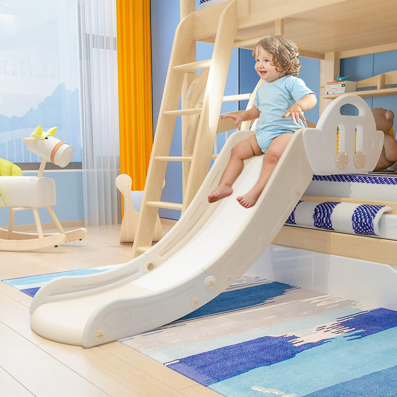 Indoor toddler slide attached to a bed and used as a Nugget couch slide accessory for active play and motor skill development