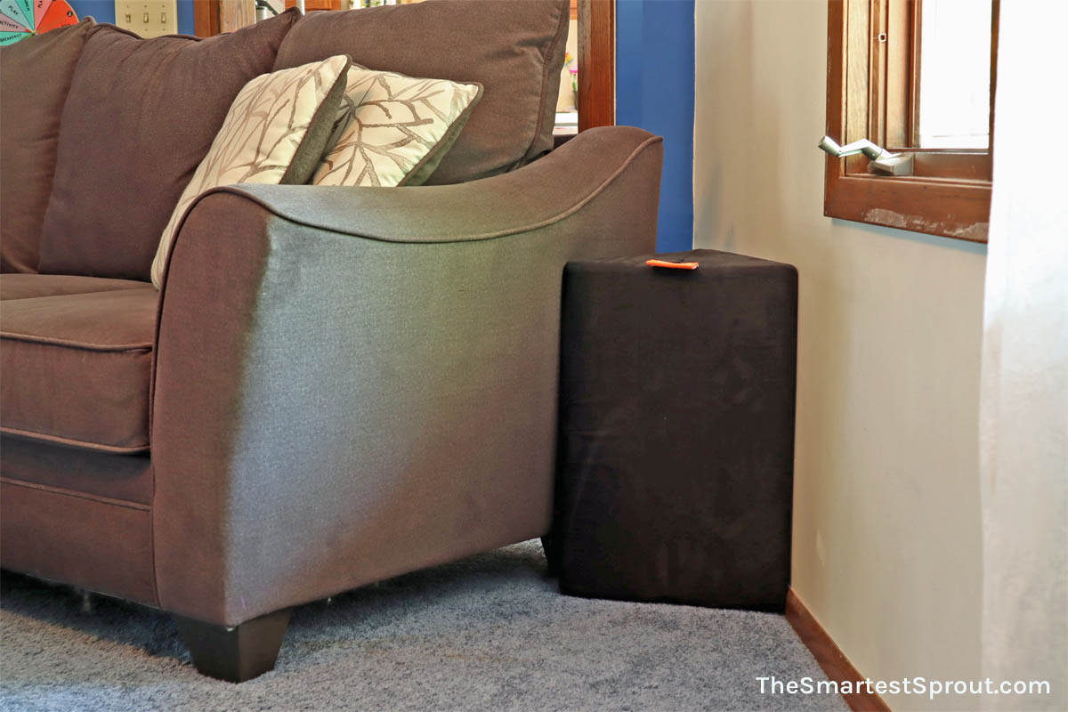 Nugget couch cube used as a toddler and pet barrier near couch