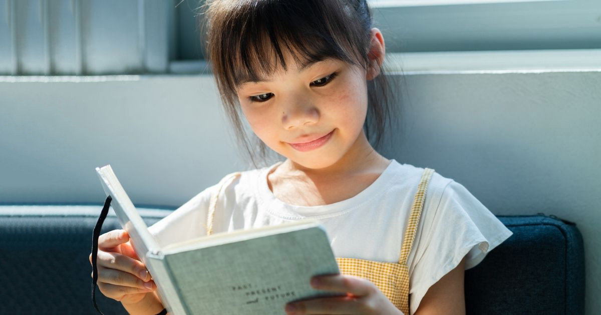 Child reading a faith based chapter book for kids