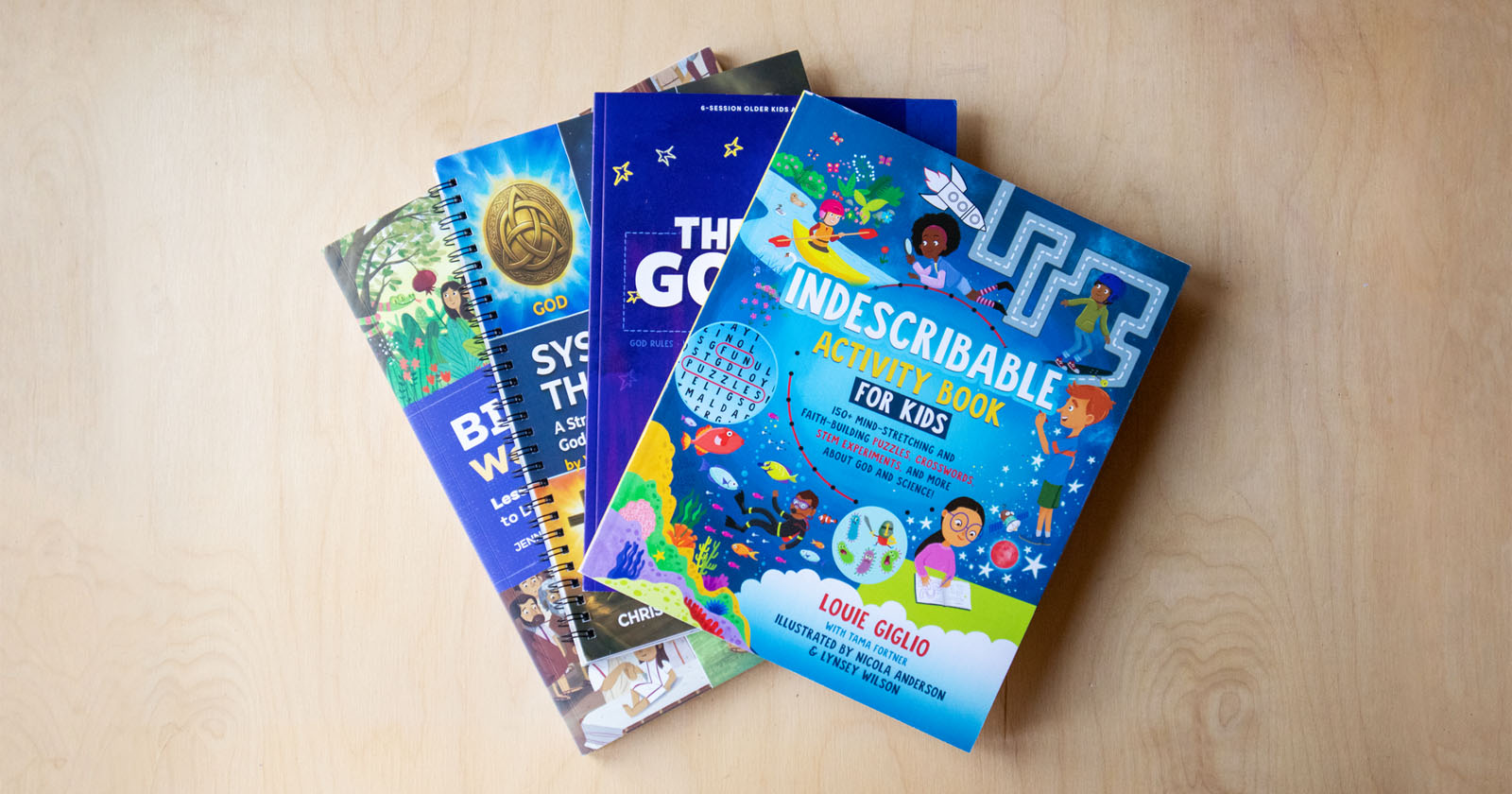 bible workbooks for kids stacked on wooden table learning christian faith at home